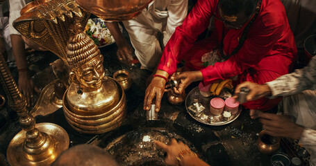 Hindu Religious Ceremony: of Group of Anonymous People Arranging Flowers Next to an Idol During a...