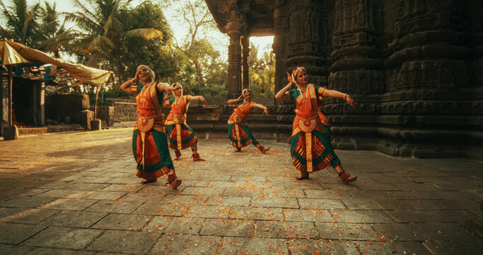 of Female Indian Lead Dancer Explaining to her Team Dancers the Moves of a Traditional Choreography. Girls in Colorful Clothes Rehearsing for a Performance in an Ancient Temple