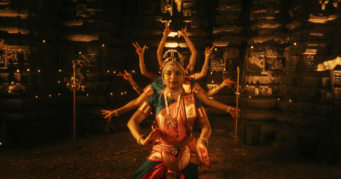 Portrait of CInematic Group of Indian Women Joyfully Dancing Traditional Folk Dance Outside of Authentic Temple. Colorful and Captivating South Asian Cultural Celebration. Zoom out