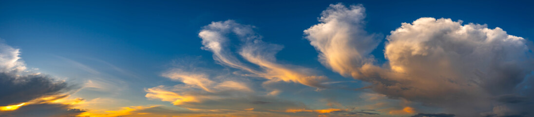 Naklejka na ściany i meble Panorama vivid sky.Panorama of a twilight sunset and colorful clouds - sunlight with dramatic cloud. Evening dusk good weather natural background.Panaramic Landscape.