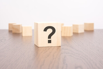 question marks blocks stand on wooden background with copy space