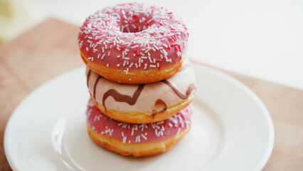 Obraz na płótnie Canvas Donuts with sprinkles and icing