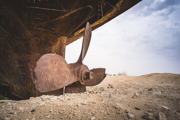 Rusty ships and boats in the desert at the bottom of the dried up Aral Sea in Uzbekistan, an...