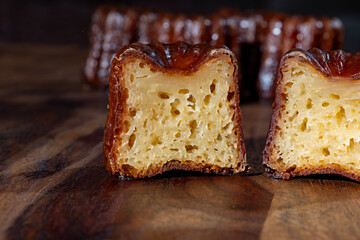 Canele, French pastry flavored with rum and vanilla, soft and tender custard center and  dark,...
