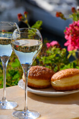 Drinking of French brut champagne sparkling wine with sweet apple Beignet, club party in yacht harbour of Port Grimaud near Saint-Tropez, French Riviera vacation, France