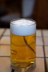 Freshly brewed German beer in craft brewery served in beer glass poured from keg