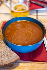 German food, thick, rich goulash meat soup served hot in bowl in old German cafe in countryside