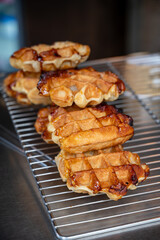 Eating of fresh baked hot Belgian sugar waffles, street food in Bruges