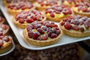 Wild fragolino strawberry and raspberry cakes in ancient city of strawberry Nemi, Castelli Romani, Italy close up