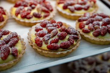 Wild fragolino strawberry and raspberry cakes in ancient city of strawberry Nemi, Castelli Romani, Italy close up