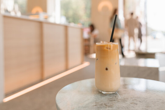 Close-up of a glass of iced coffee on a table in a cafe