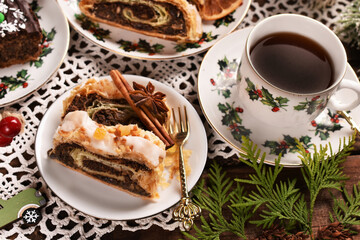 Christmas poppy seed chocolate cake and a cup of coffee on festive table top view