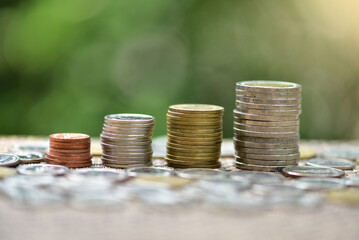 Stacked coins forming growing graph. Financial concept.