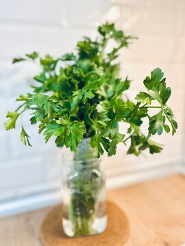 Close-up of a bunch of fresh parsley in a glass of water