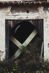 Abandoned after invasion house at Ghost city and a boarded-up front door