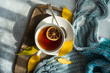 Overhead view of a cup of spiced black tea with lemon and autumnal styling