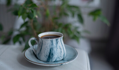 A cup of coffee on white surface.Close-up of hot coffee cup.Hot Coffee Drink Concept