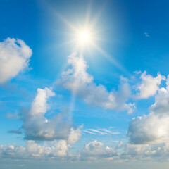 Naklejka na ściany i meble Blue sky , sun and beautiful white clouds.