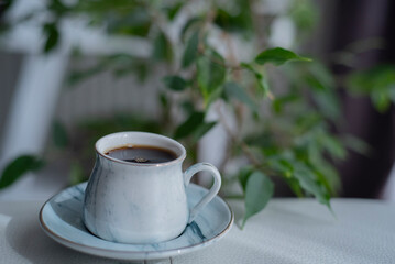 A cup of coffee on white surface.Close-up of hot coffee cup.Hot Coffee Drink Concept