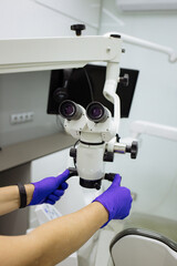 close-up of dentist's hands. Manipulating a dentist's instrument.dental office. dentist's tool. drill. armchair. color palette. nippers, scalpels. Dental equipment. Closeup photo of dental handpieces 