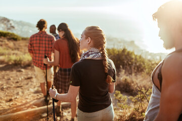 Enthusiastic friends navigate a forest trail during their hiking adventure