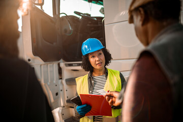 Safety supervisor discussing procedures with a truck driver