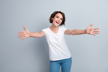 Photo of funky excited lady wear white t-shirt open arms ready hug you isolated grey color...