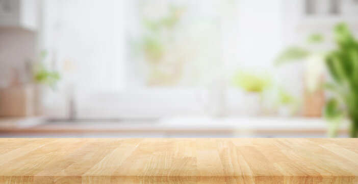 Selective focus.Wood table top on blur kitchen counter background.