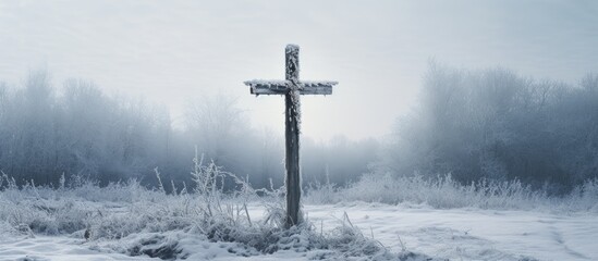 Christian symbol of crucifixion on wayside cross in winter - obrazy, fototapety, plakaty