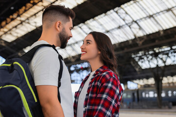 Long-distance relationship. Beautiful couple on platform of railway station, space for text