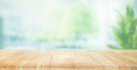 Selective focus.Empty of wood table top on blur of curtain with window and green from garden...