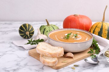 Delicious pumpkin soup served on white marble table