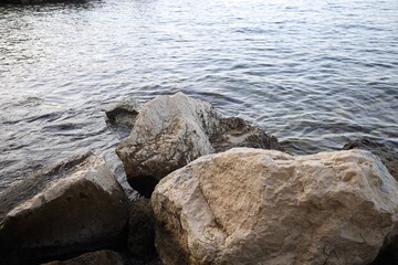 Beautiful view of sea coast with stones on summer day