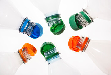 Plastic bottles with tethered caps in different colors - obrazy, fototapety, plakaty