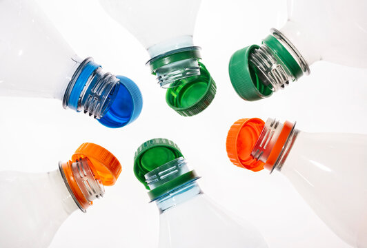 Plastic bottles with tethered caps in different colors