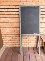 The black board with the metal stand for notification of promotions.