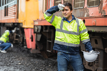 Tired fatigue stress locomotive repair worker engineer on duty train maintenance service staff hard work. © Quality Stock Arts