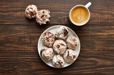 Chocolate meringue cookies and cup of coffee