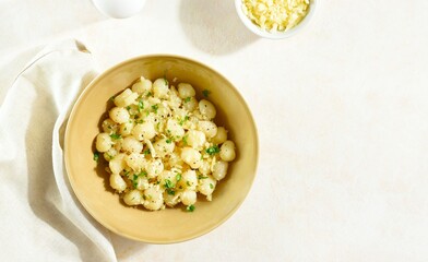 Potato gnocchi with parmesan cheese and greens