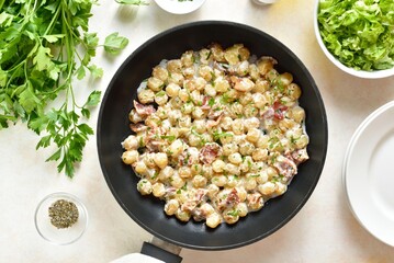 Potato gnocchi with bacon in pan