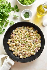 Potato gnocchi with bacon in pan