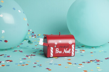 Santa's famous letterbox surrounded by confetti and balloons