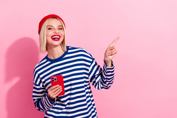 Photo of nice young blogging girl enjoy discount coupon finger pointing empty space iphone app...