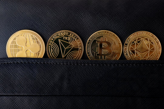 Criptomonedas y tecnolog&iacute;a.
Bitcoin,Ethereum,XRP y TRX monedas de oro sobre fondo negro. Concepto de finanzas e inversi&oacute;n.