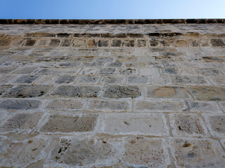 Ancient brick stone wall in front of blue sky