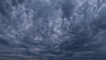 pretty skyscape of sky with massive rain or snow clouds backdrop - photo of nature