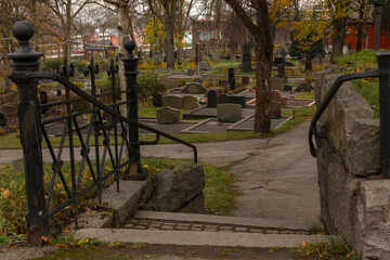Stairs leading to a well-kept cemetery on an autumn day