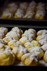 Fluffy profiteroles, cream puffs with vanilla cream and icing sugar. homemade dessert for dessert	