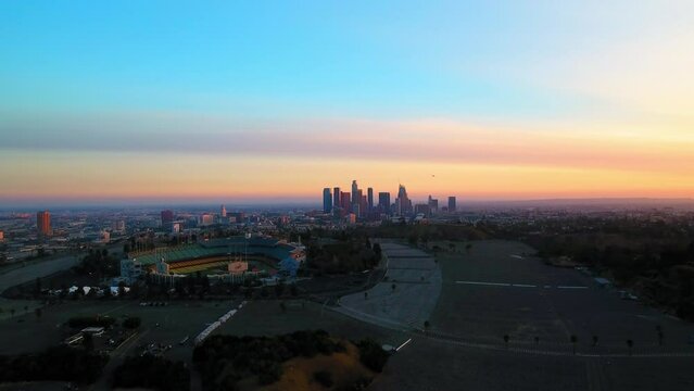 Aerial Backward Shot Of Dodger Stadium Near Downtown Against Sky At Sunset - Los Angeles, California