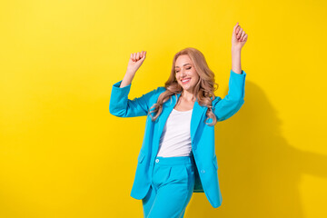 Photo of lovely overjoyed cheerful girl closed eyes enjoy dancing chilling isolated on yellow color...